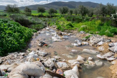 Water pollution caused by agricultural waste and plastic blocking stream